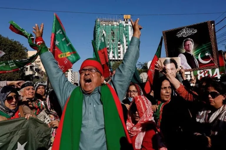 PTI supporters as they gather during a protest, outside the provincial election commission office