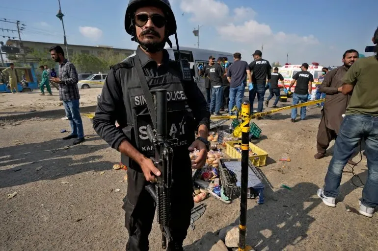 A police officer at the site of a suicide attack in Karachi, Pakistan, on April 19, 2024